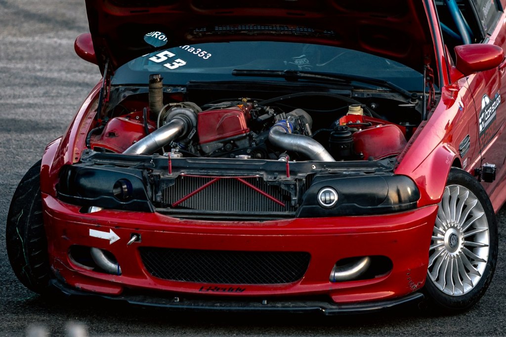Il vano motore di un'auto da corsa rossa con un turbo elaborato